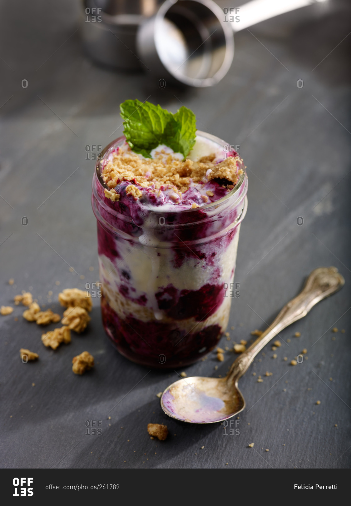 A mason jar parfait and spoon stock photo - OFFSET