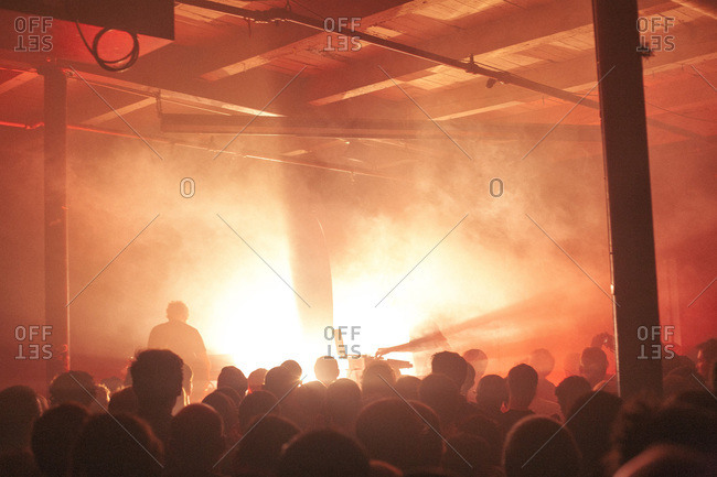Crowd watching musicians on stage in smoke