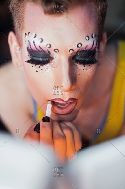 Man applying drag queen cosmetics