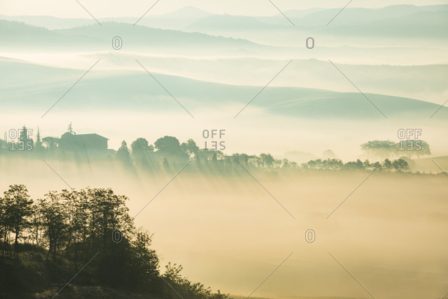 View of Val d'Orcia at dawn in the fog