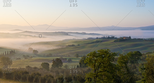 View of Val d'Orcia at sunrise in the mist