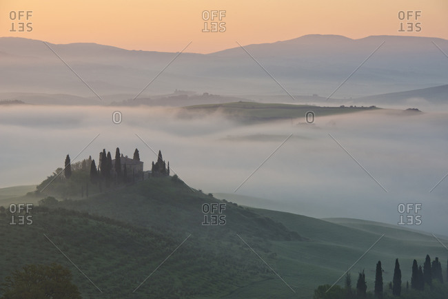 View of the rolling landscape of Val d'Orcia at dawn