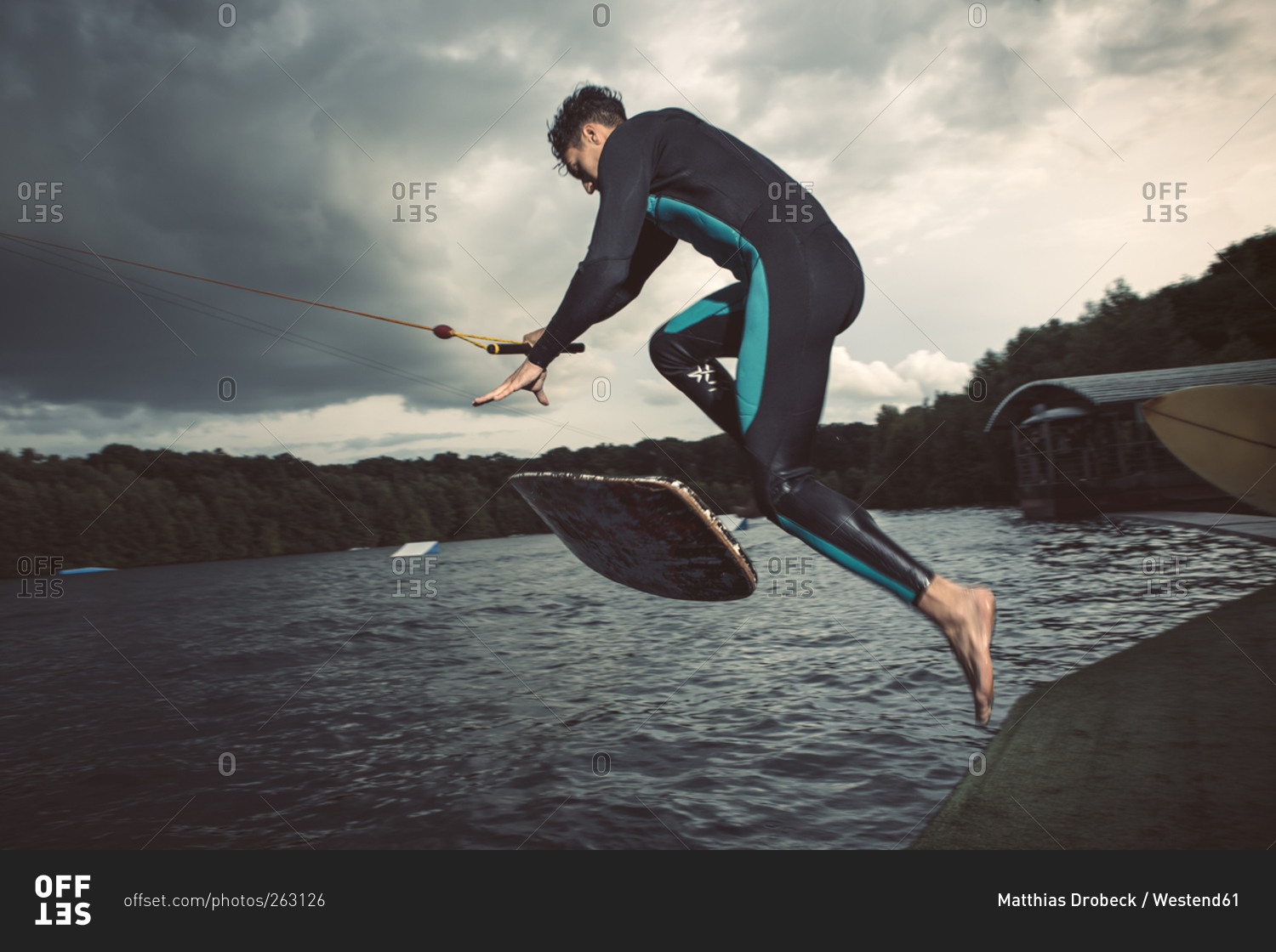 Young wakeboarder jumping in the air