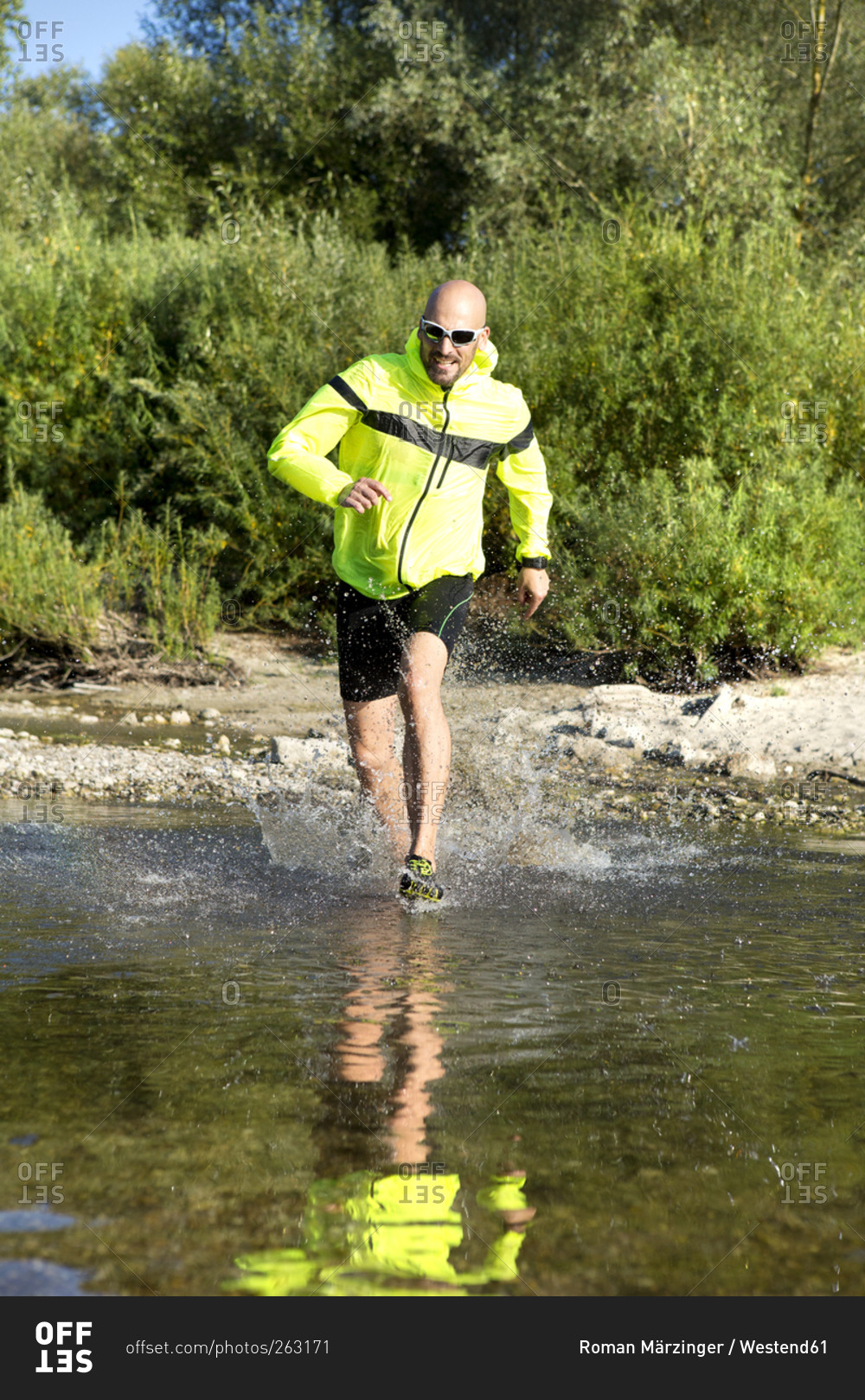 Man in sports wear sprinting in water