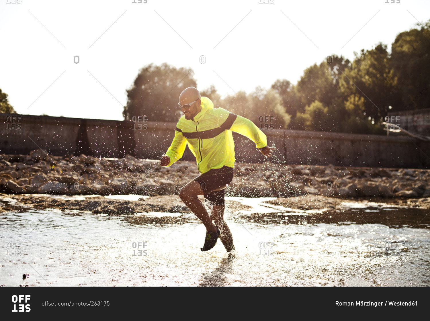 Man in sports wear running in water