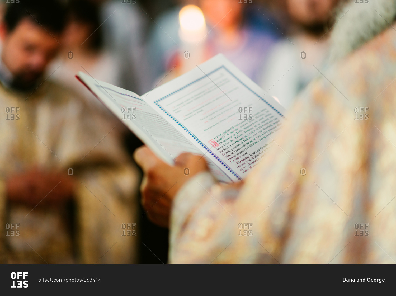 Orthodox Romanian priest with book during wedding
