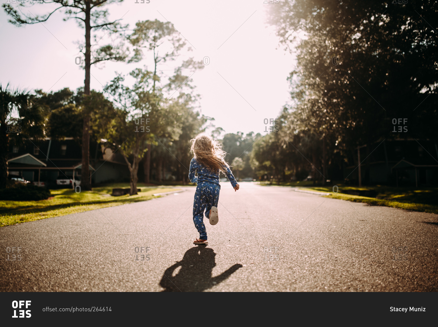 Little girl in her pajamas running on a neighborhood street stock photo ...