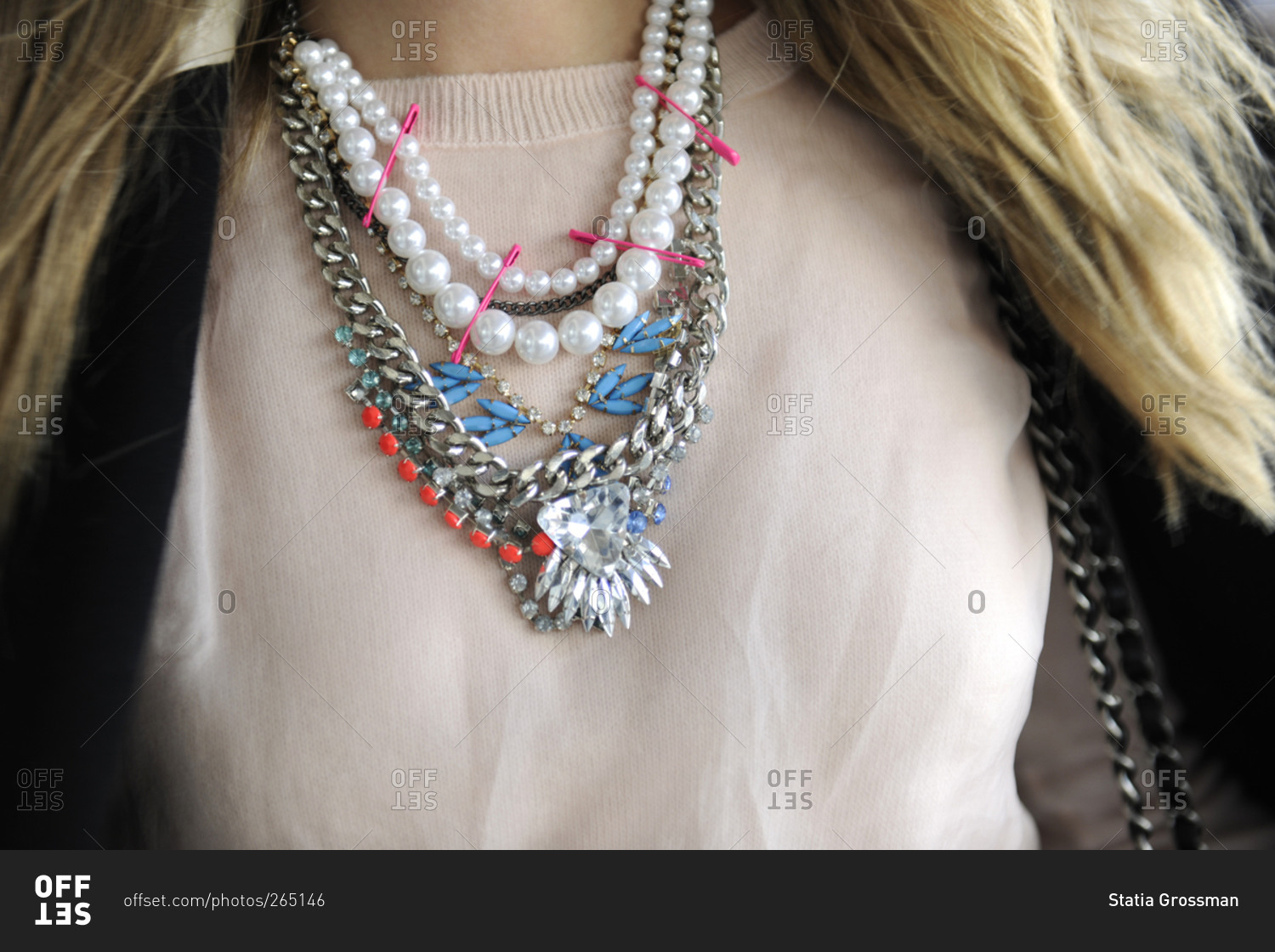 A woman wears a mix of necklaces