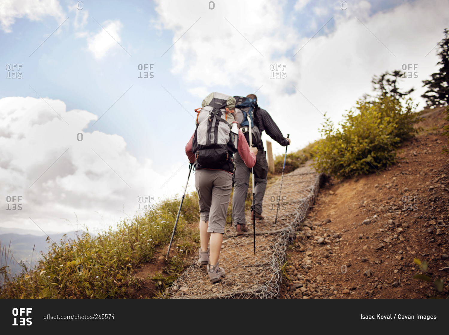 Couple hiking up a steep path in Oregon