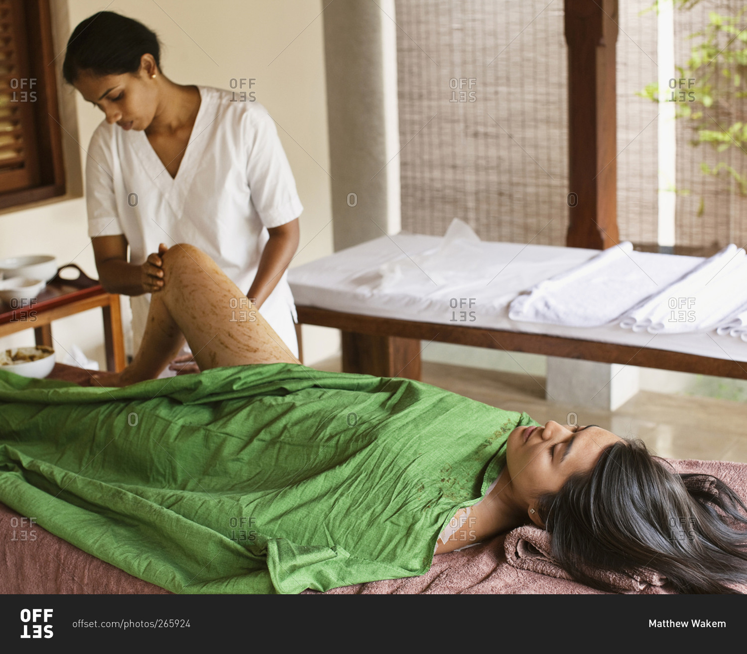 Young woman receiving a body wrap spa treatment