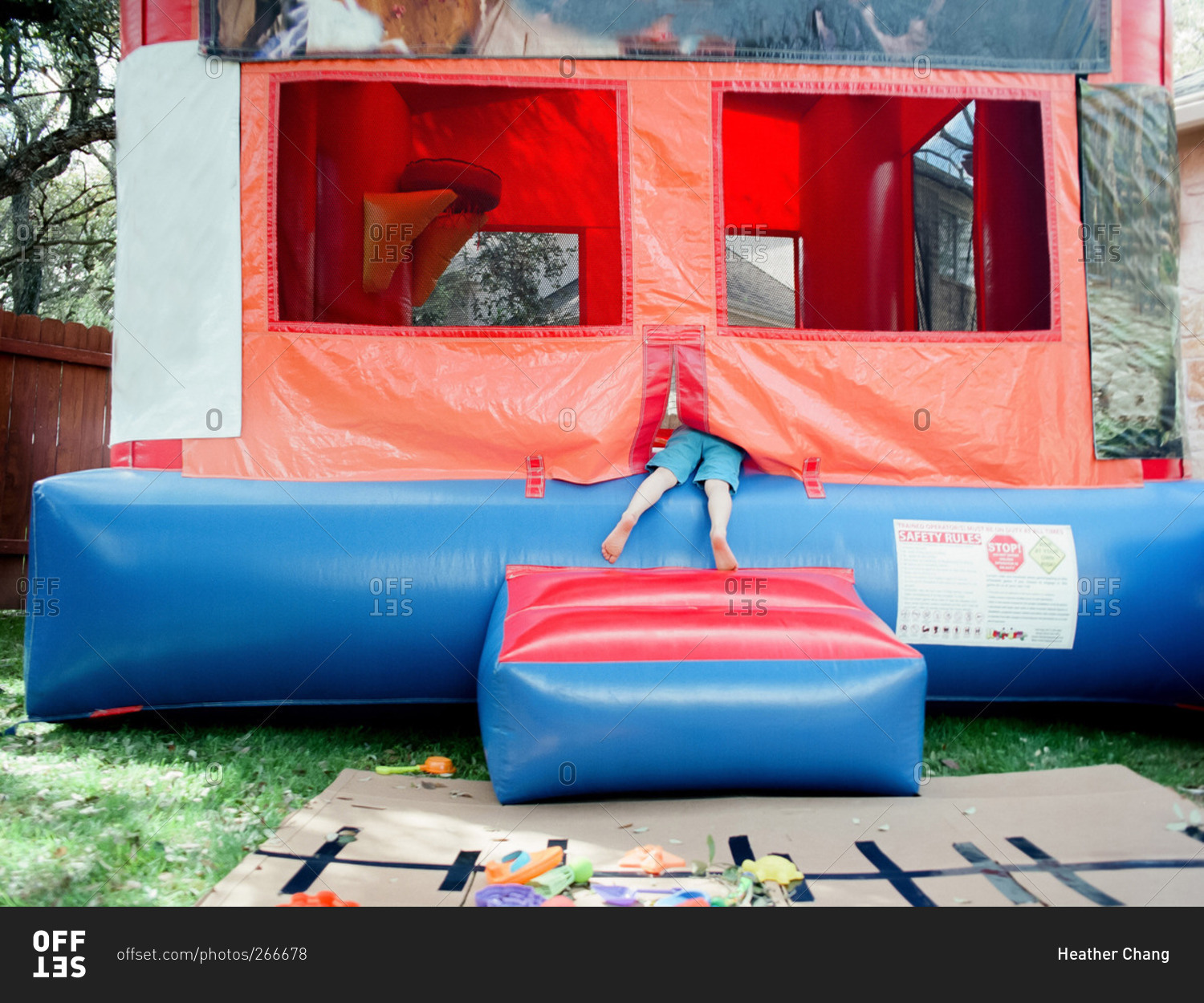 Feet of a little boy climbing into a bouncy house