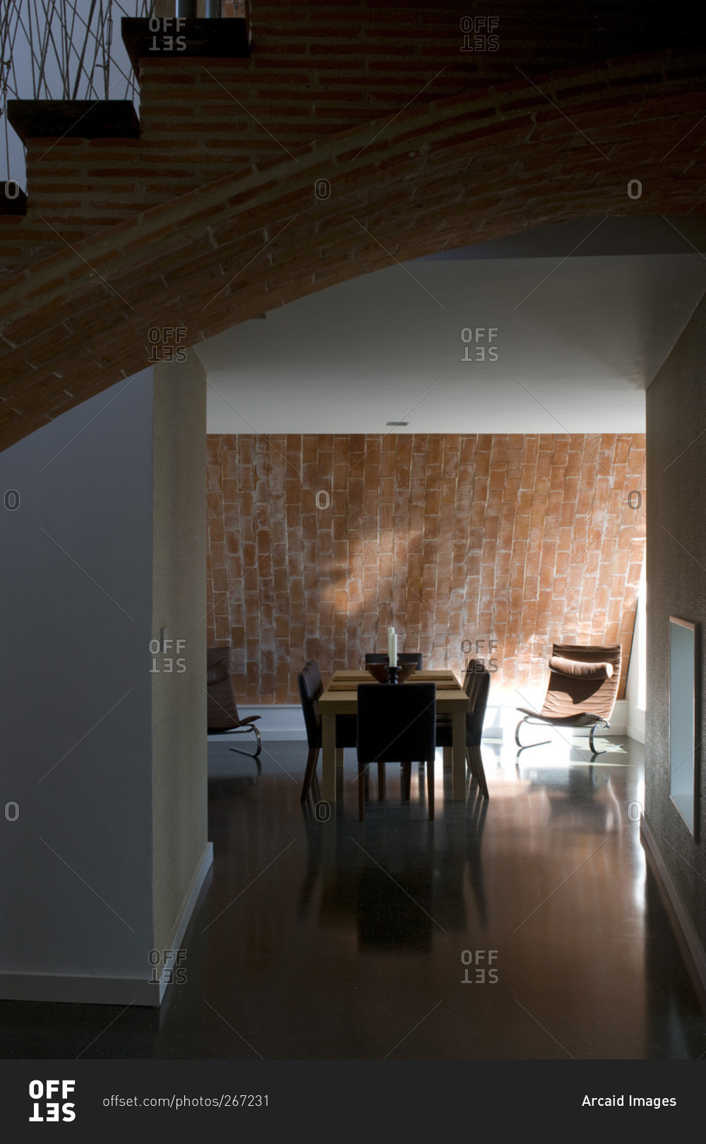 Open plan dining room and exposed brick staircase in a zero carbon house