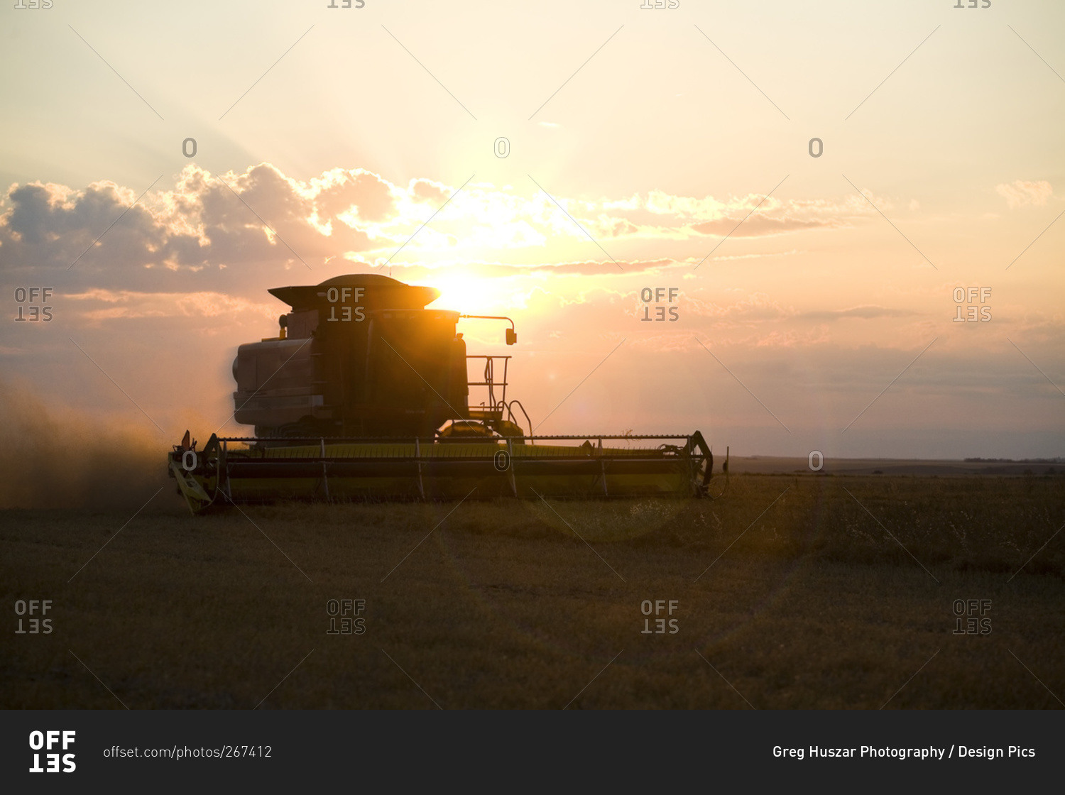 Silhouette Of Working Combine At Sunset, Saskatchewan