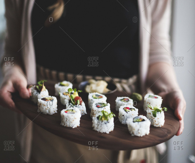 Woman with tray of homemade sushi