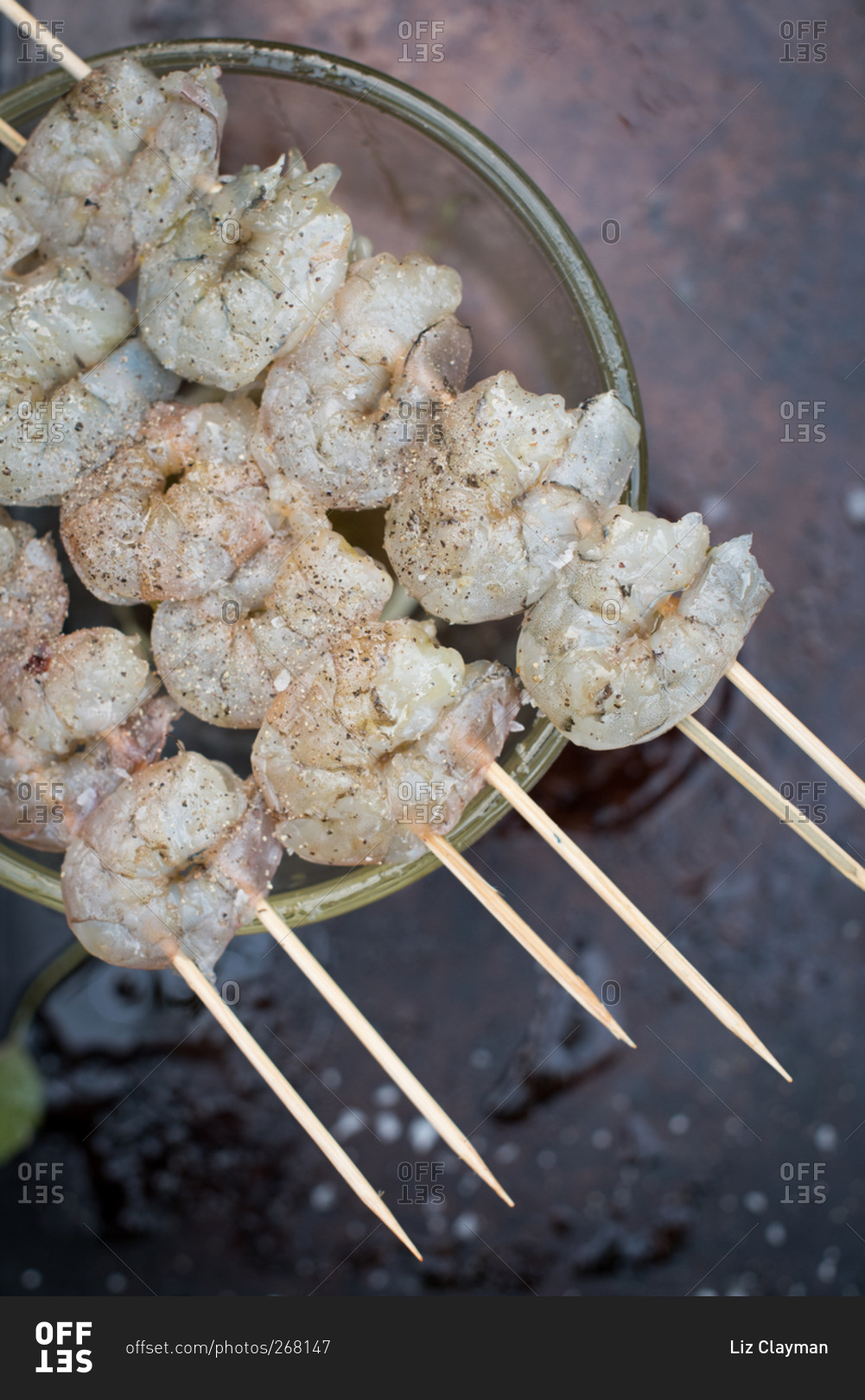 Uncooked seasoned shrimp on skewers
