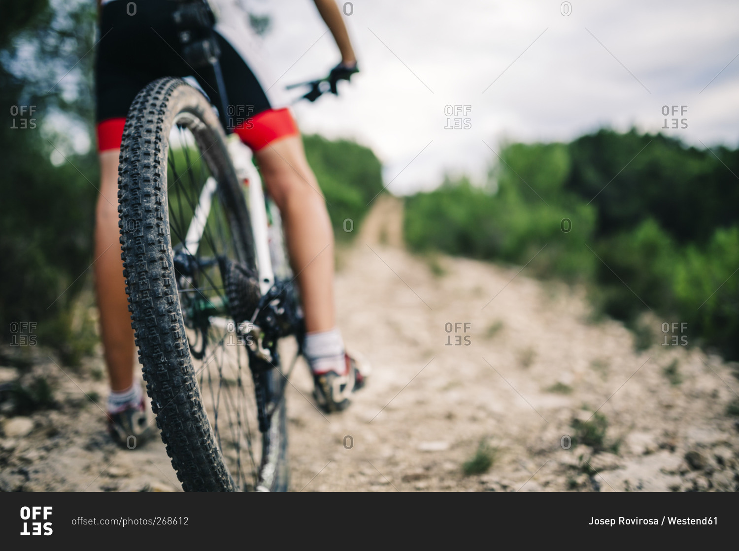 Mountain biker in extreme terrain, rear view, Tarragona, Spain