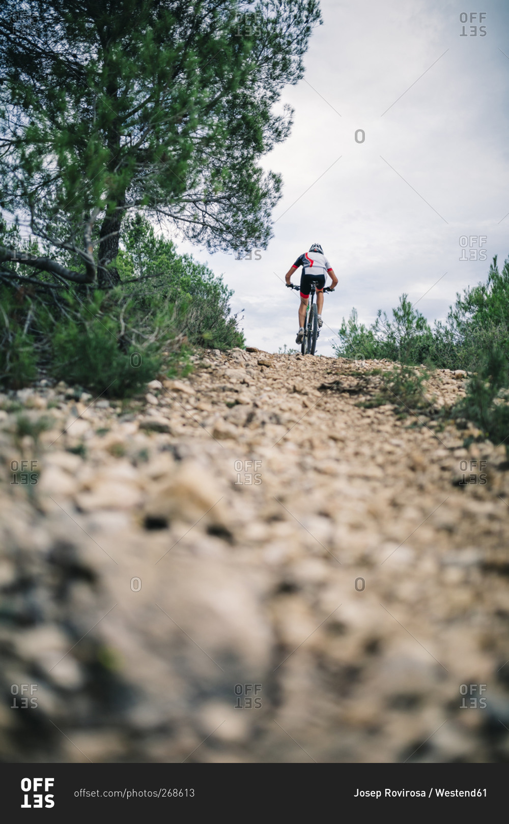 Mountain biker in extreme terrain, rear view, Tarragona, Spain