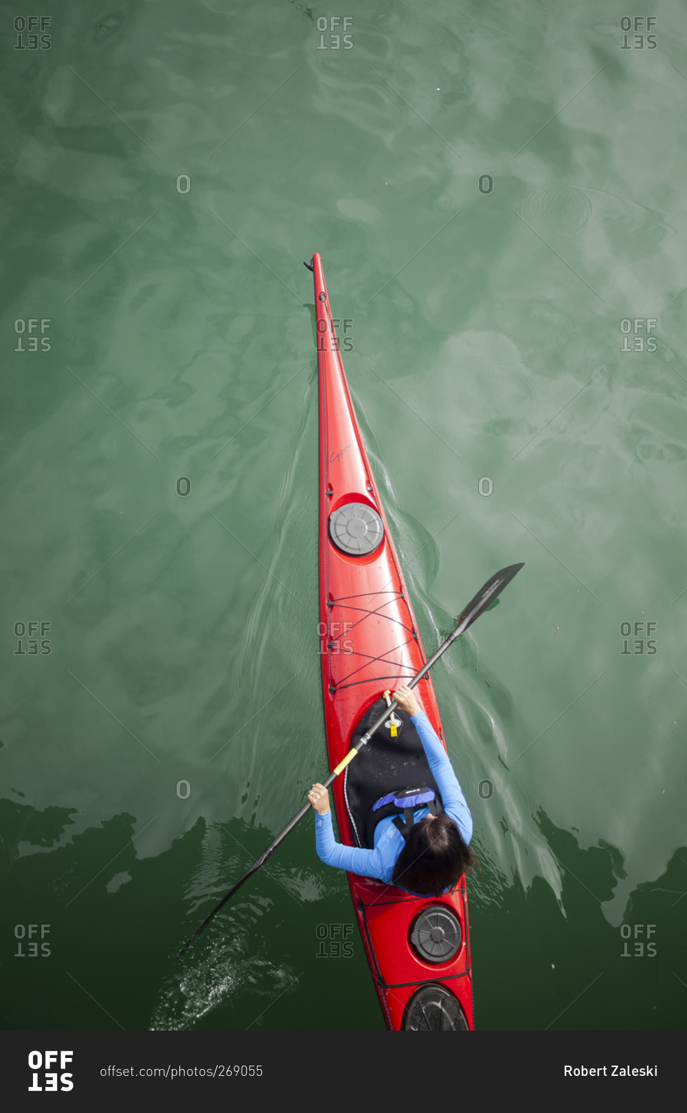 Woman paddling a sea kayak in Dana Point harbor, California