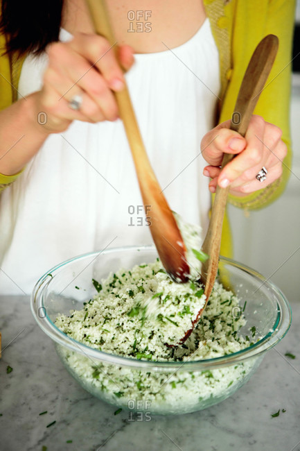 A woman stirring cauliflower couscous