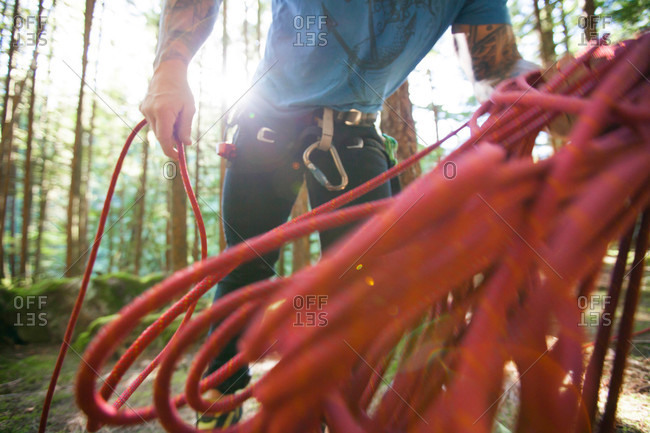 A climber works to coil his rope after a day of sport climbing