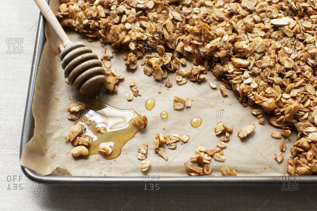 Oats and honey in pan for granola