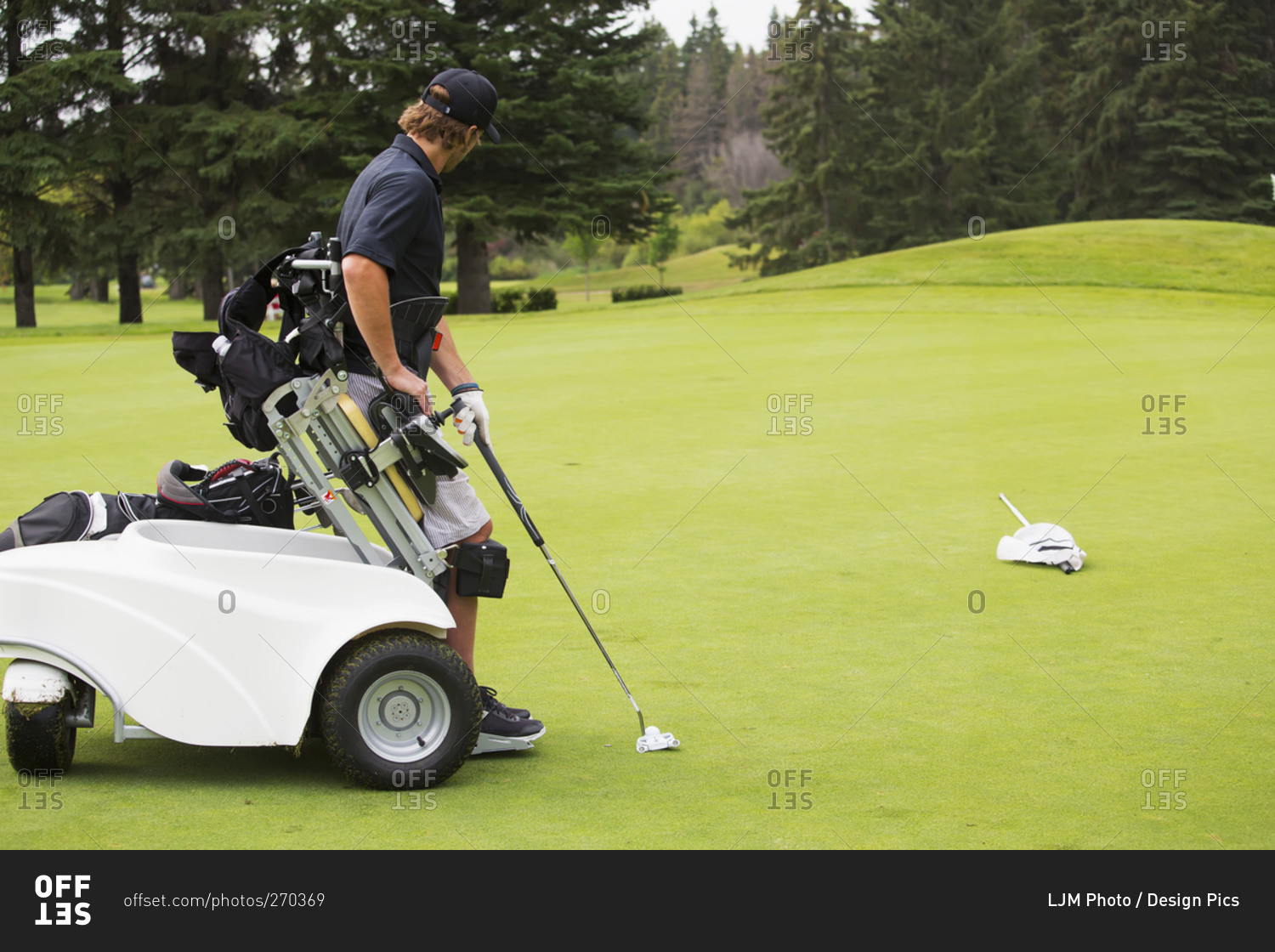 Disabled golfer in a tournament using high tech mobility aid, Edmonton
