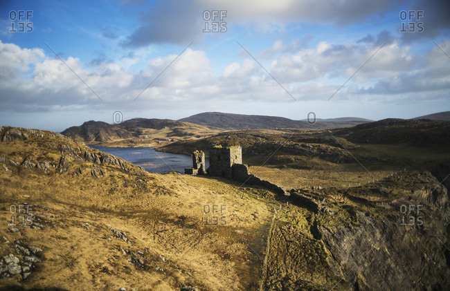 Arid mountainous landscape with ruins of wall and building in West Cork, County Cork, Ireland