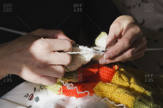 Knitting a woolen multi-colored scarf, London, England