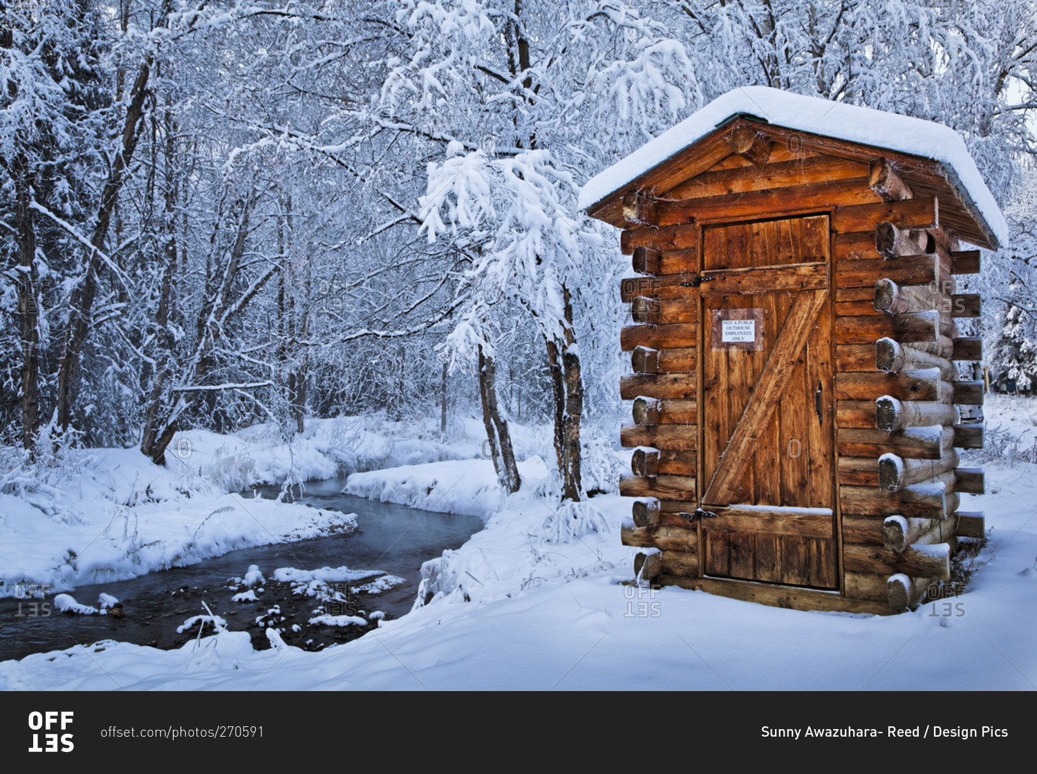 Log outhouse by a meandering creek in snow, Chena Hot Springs Resort