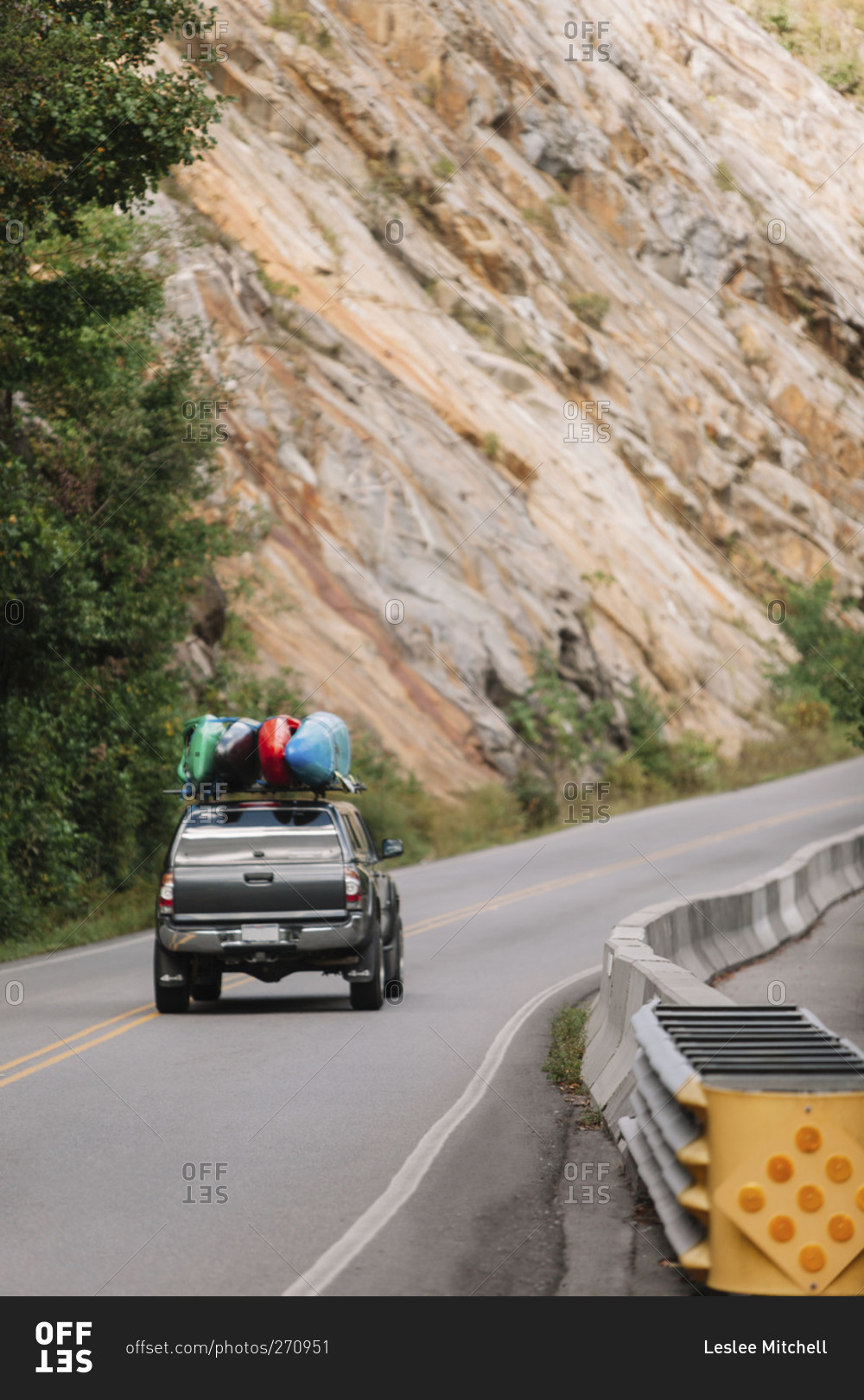 Truck with kayaks traveling on a mountain road