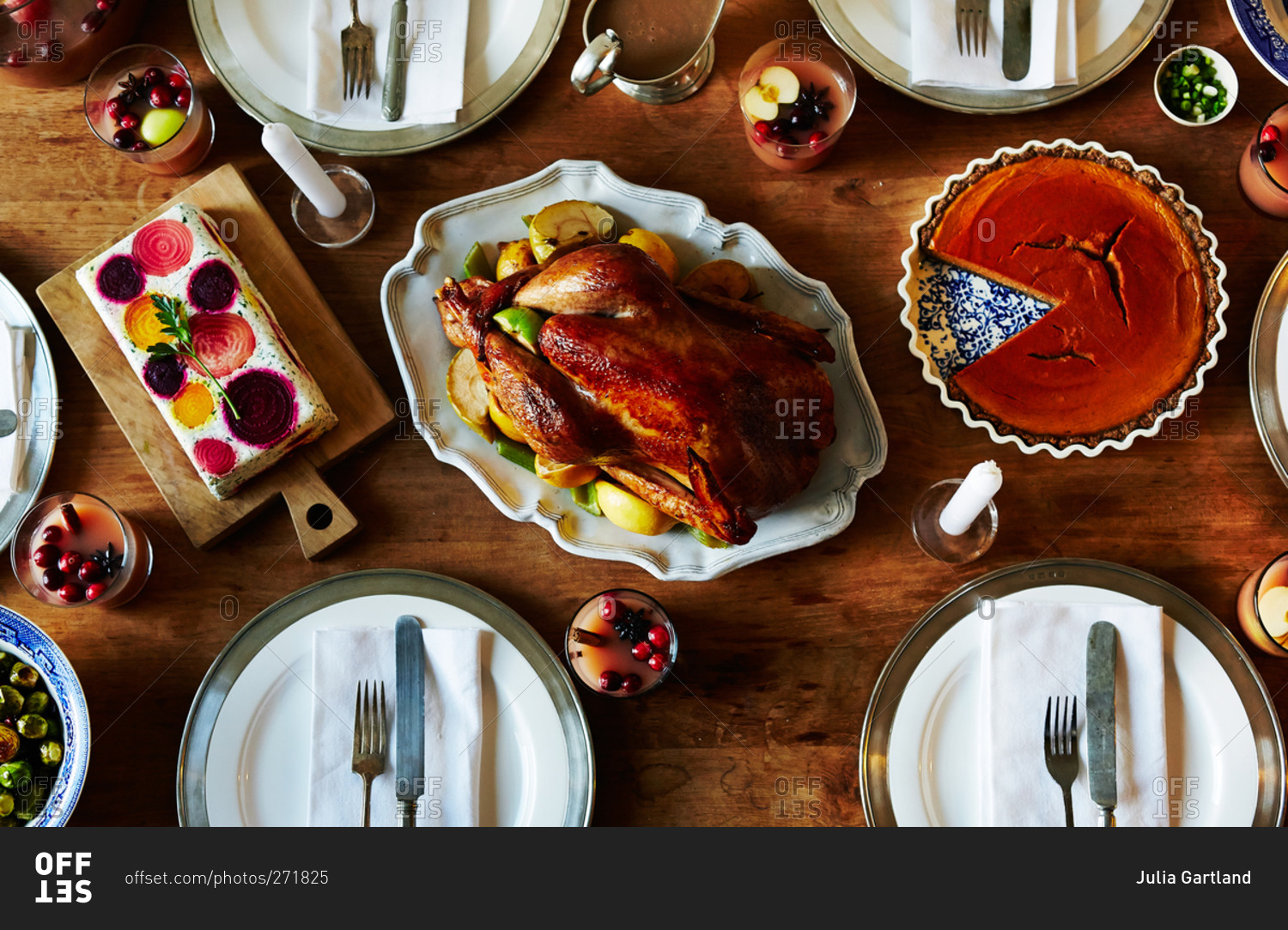 Overhead view of a Thanksgiving dinner table with roasted turkey