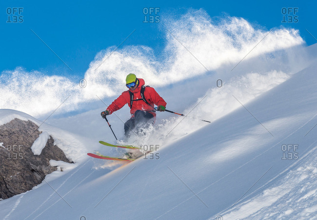 A skier skiing powder snow in the Austrian mountains