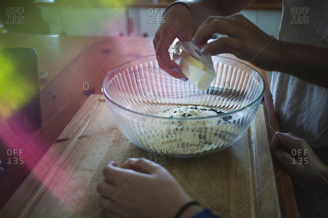 Close-up of hands of two teen girls making cookies