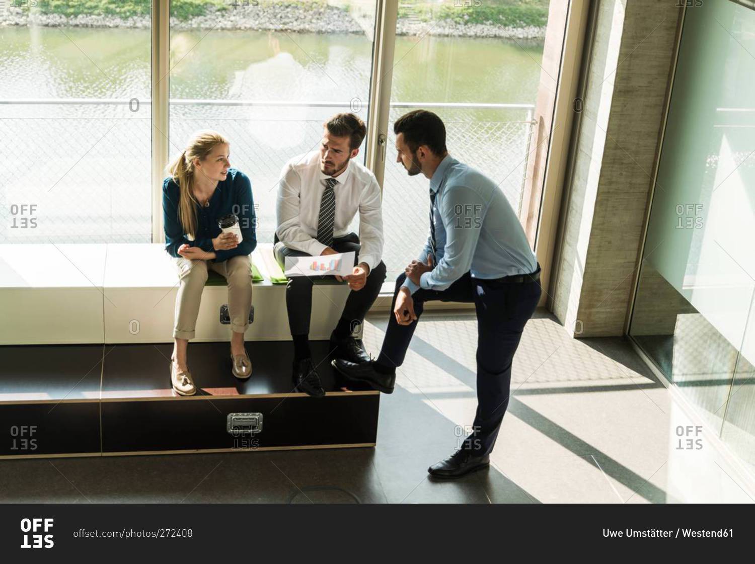 Three young business people discussing document