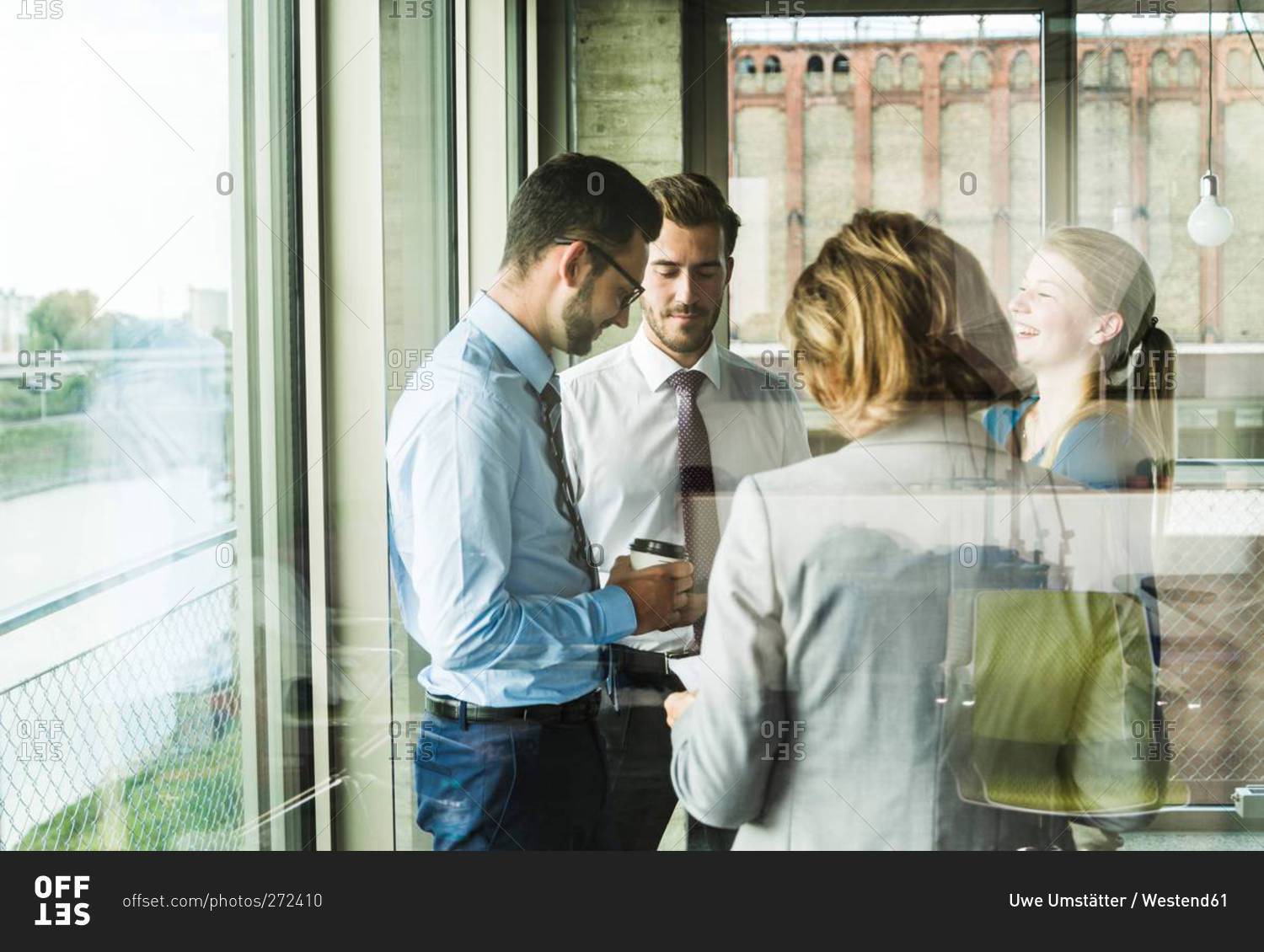 Business people talking at the window
