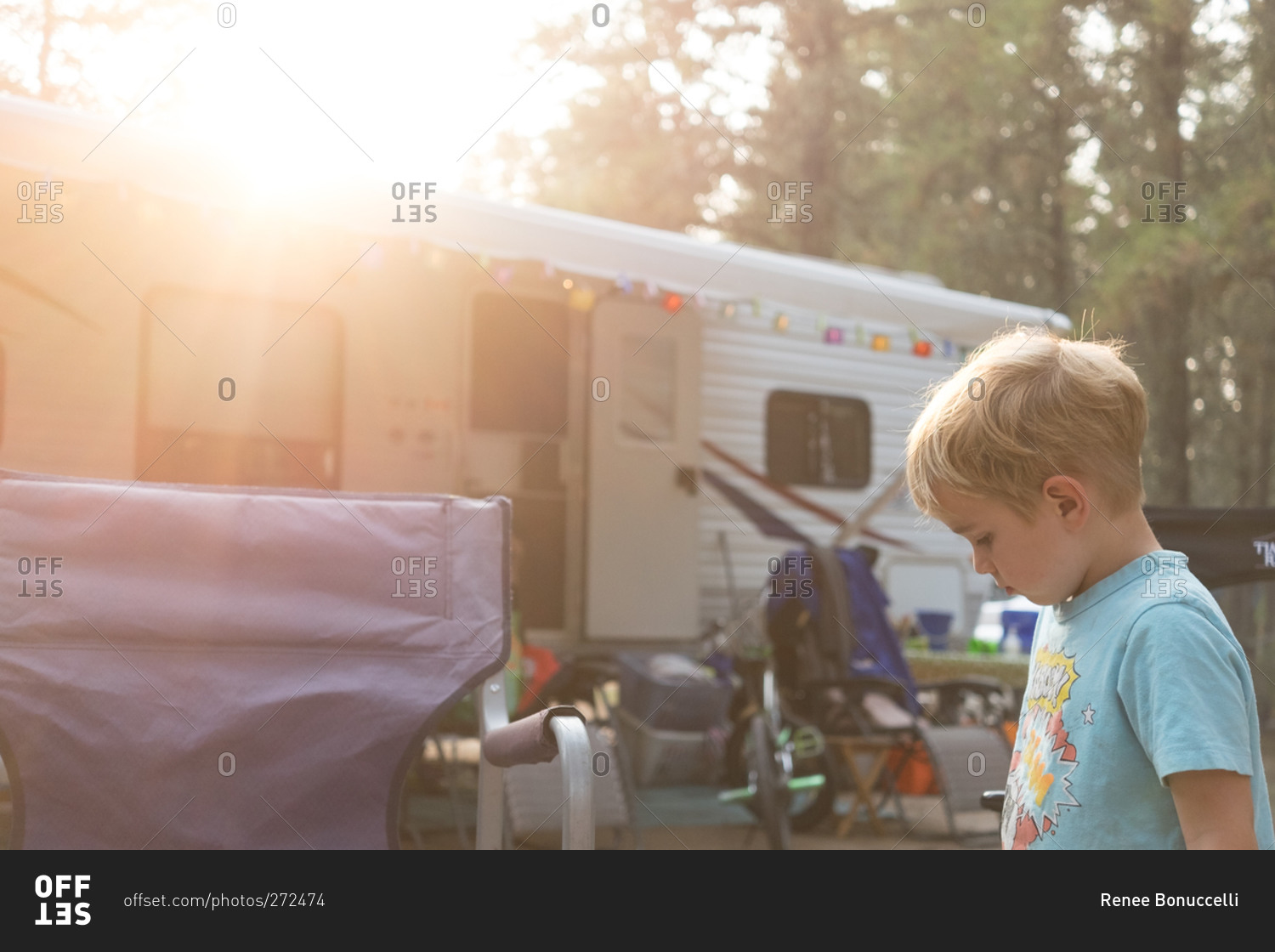Young boy at campsite next to trailer