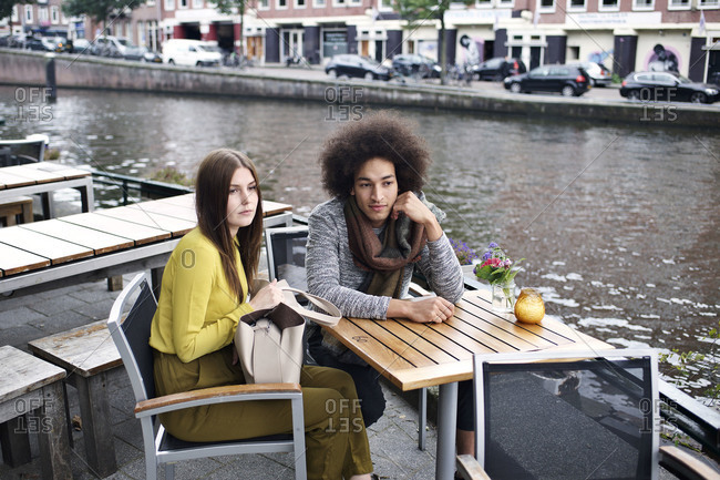Man and woman at canalside table in Amsterdam
