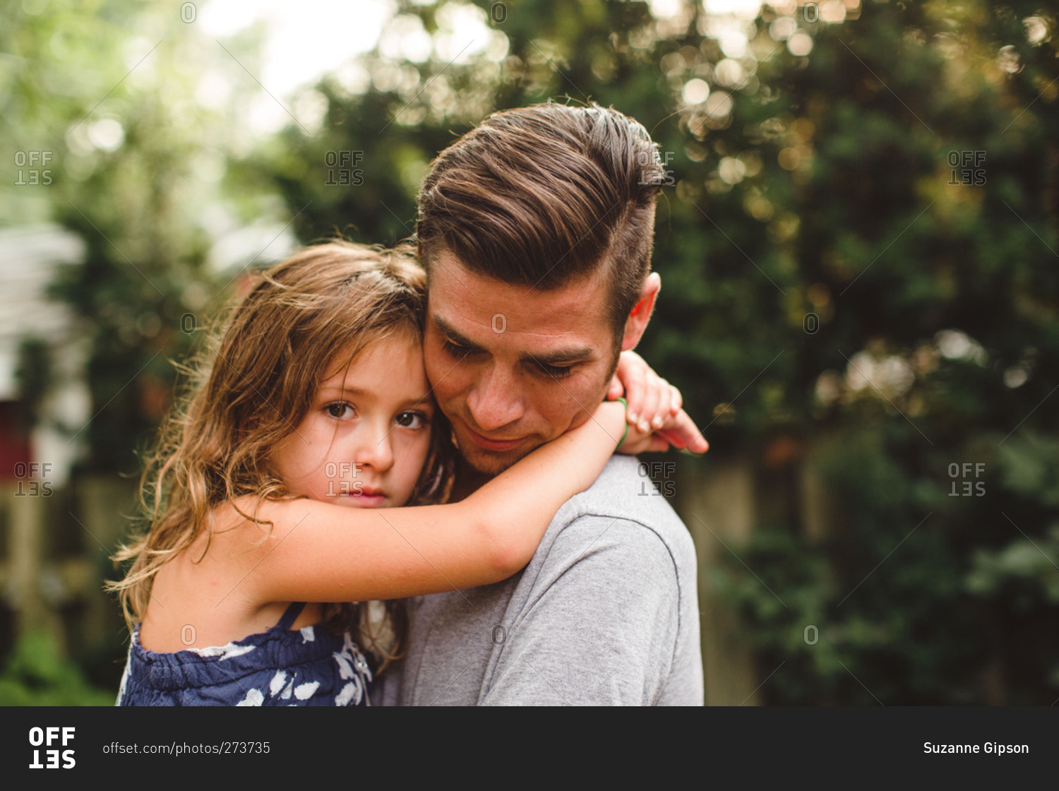 Little girl being held her father stock photo - OFFSET