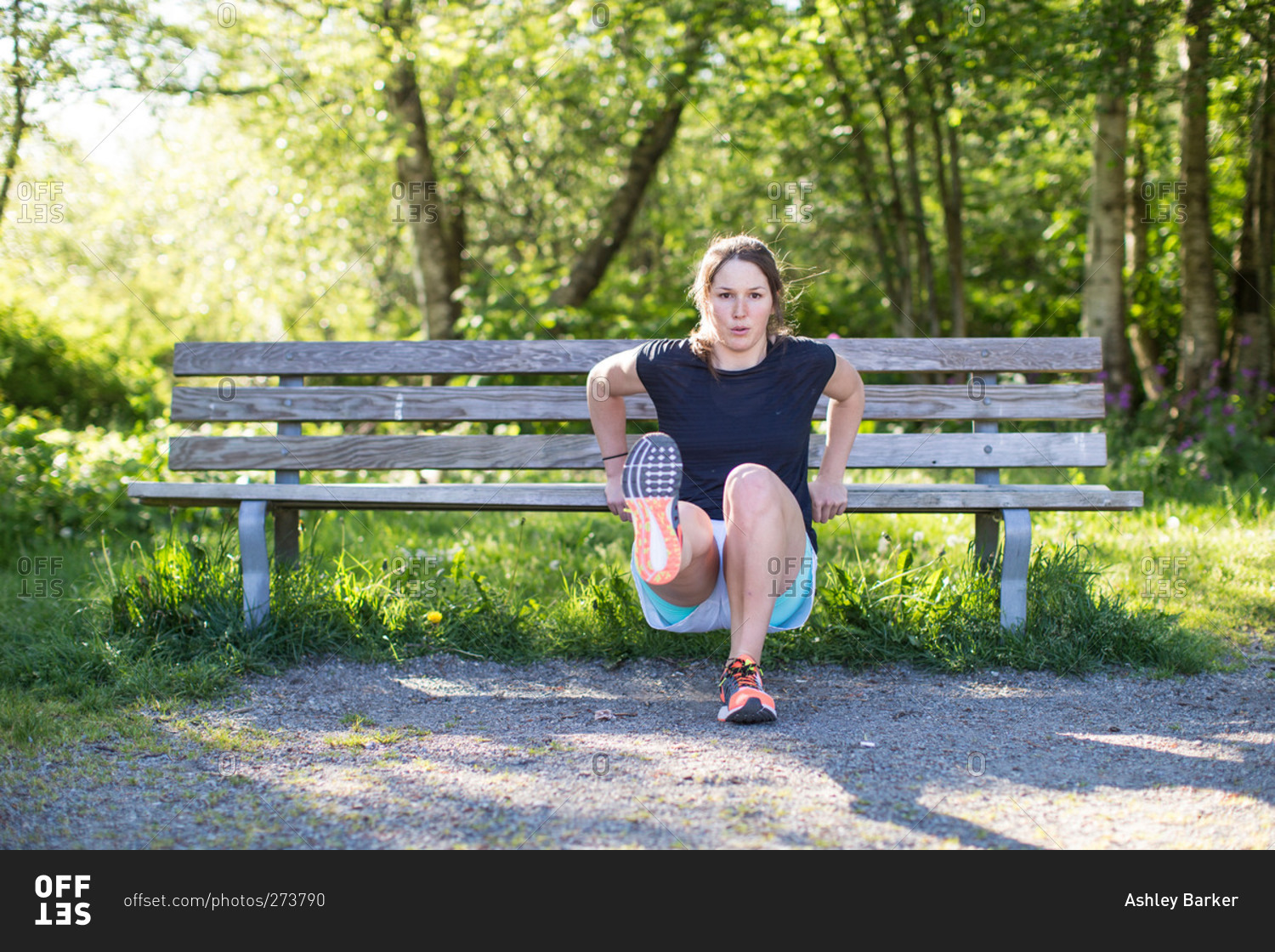 Woman doing workouts with bench in park