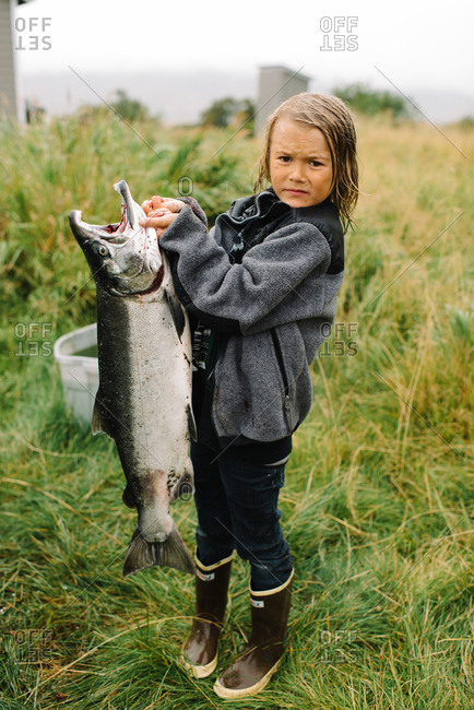 Boy holding a big fish she caught