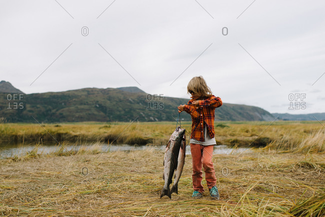 Boy carrying the fish he caught
