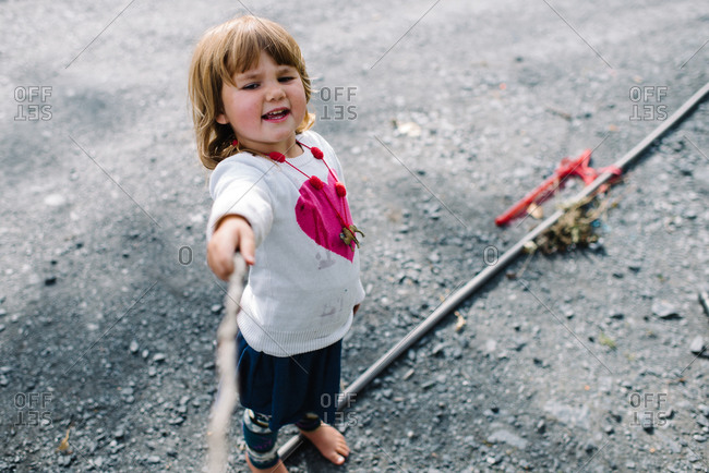 Girl playing with a stick