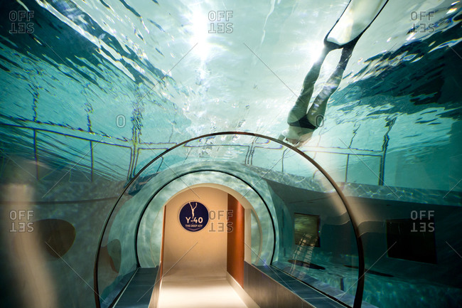 Padua, Italy - December 9, 2014: Man swimming above the observation tunnel of Y-40, the deepest pool in the world