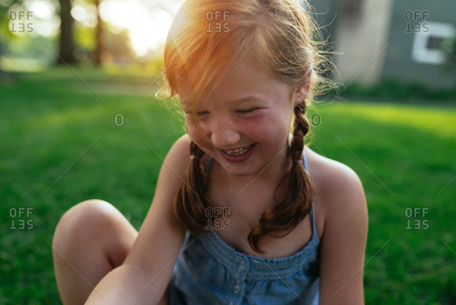 Girl with red hair and freckles laughing