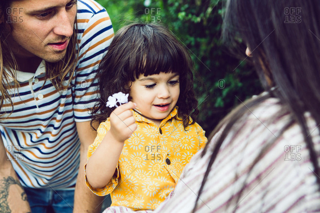 Close-up of young child giving mother a flower