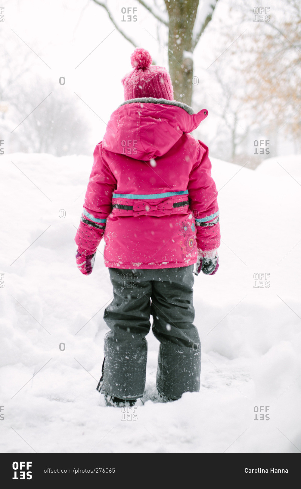 Girl in winter gear standing in the snow