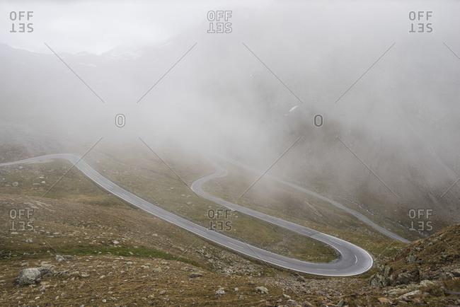 Desolate road on a foggy mountain