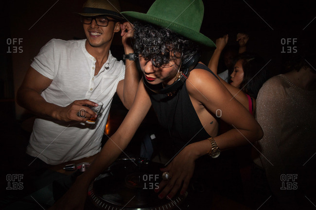 Young woman DJing at a party