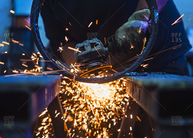 Close up of a man shaping a piece of metal