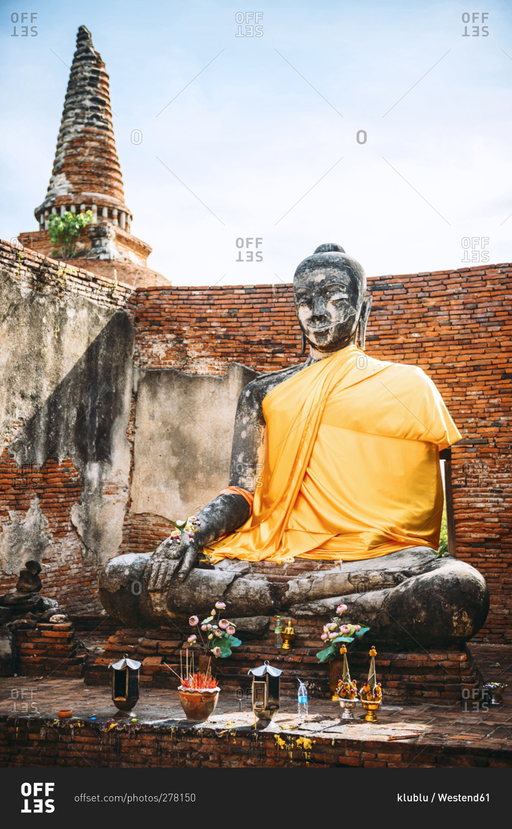 View to ancient Buddha statue covered with yellow cloth, Ayutthaya